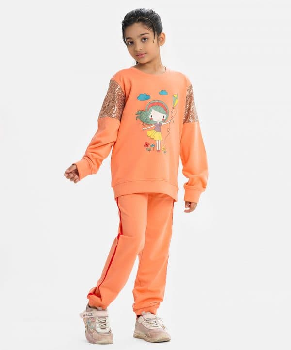 Kid girls' cartoon-printed top and bottom set in soft French terry fabric. Long-sleeved top with sequined detail and pants with twill tape, elastic waist, and adjustable drawstring.