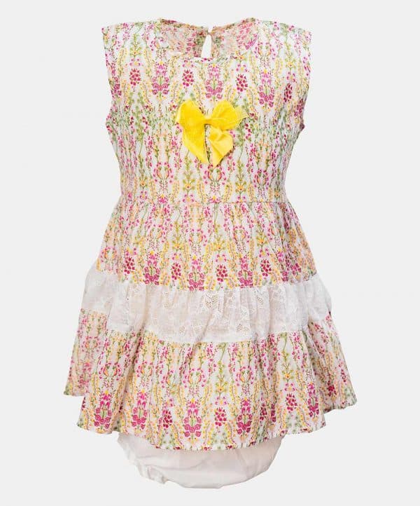 Sleeveless tent-style newborn baby girls frock in cotton fabric. All-over floral printed with lace work at hemline and attached ribbon bow. Completed with baby pants.