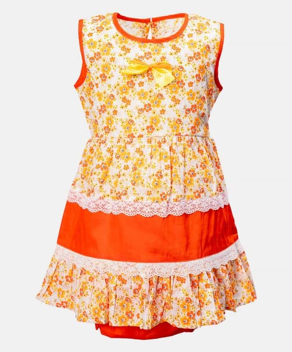 Sleeveless tent-style newborn baby girls frock in cotton fabric. All-over floral printed with lace work at the waistline and hemline. and attached ribbon bow. Completed with baby pants.