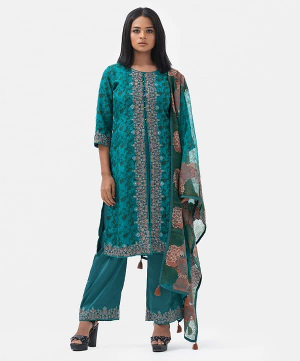 Women's exclusive layer style salwar kameez from the Nargisus by Le Reve. Printed kameez in muslin fabric with a crepe inner. Round neck, three-quarter sleeves and heavy karchupi at the front. Muslin dupatta with patch border and solid color pajama.